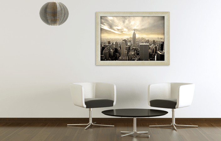 Aluminium Poster Frame Sideloader Modern F015 in champagne color with cross-brushing, with poster of Manhattan, placed in interior of light colours. Picture frame producer Debex Suisse.