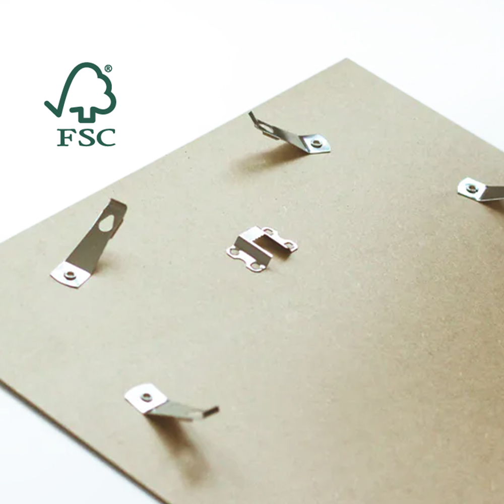 Rear view of an FSC certified picture frame backing with metal clips and a saw-tooth hanger.