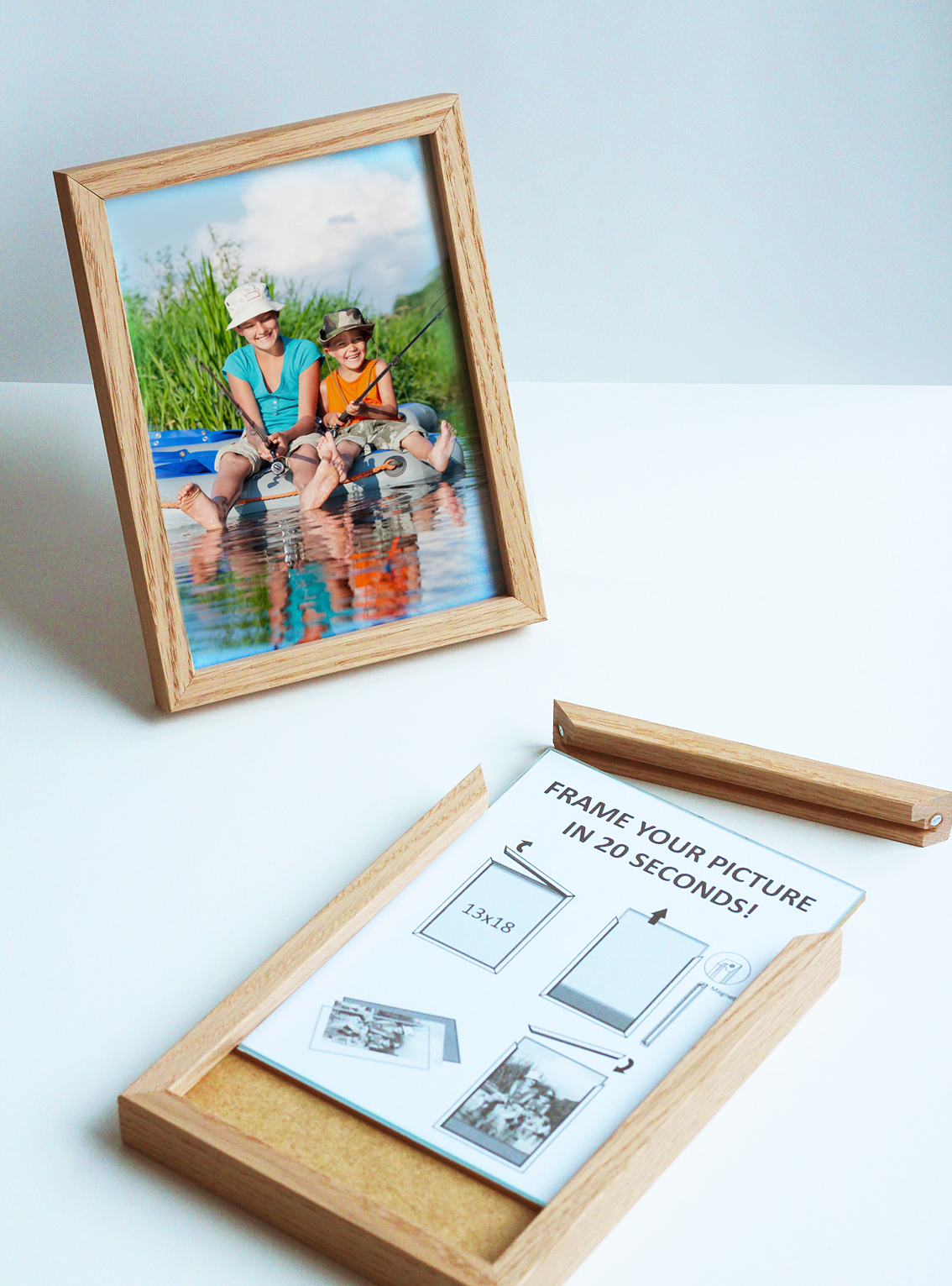 Oak wood magnetic frame with instruction marketing inlay, illustration of detaching the magnetic side of the frame and taking away the glass with sliding backside, tabletop magnetic frame with framed family portrait in the background. Produced by Debex Suisse.